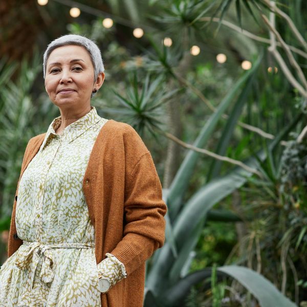 Portrait of a smiling woman with natural background.
